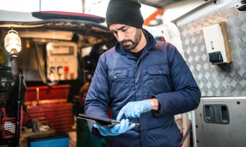 man with ipad working in factory