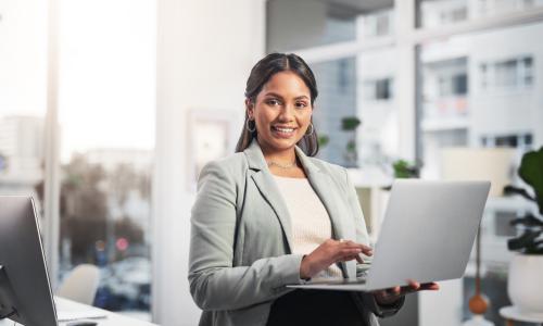 ICT sales rep working on her computer in an office